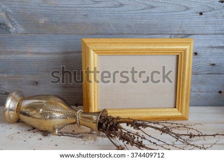 picture frame gold frame in still life wood background