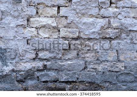 Old damaged gray wall without plaster - texture
