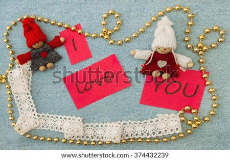 Valentine, greeting card with knitting couple in love and golden beads. Lettering  I need you on the denim background. Handmade concept
