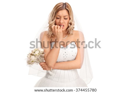 Young nervous bride in a white wedding dress biting her fingernails isolated on white background  Royalty-Free Stock Photo #374455780