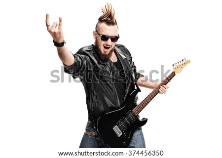 Studio shot of a punk rock guitarist playing guitar and making rock gesture isolated on white background Royalty-Free Stock Photo #374456350
