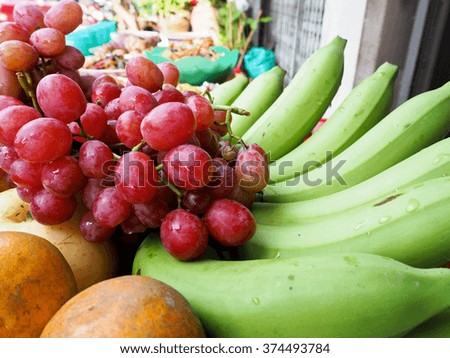 This tray is composed of various fruit such as red grape, banana and orange , a sacrificial offering in Chinese New Year.