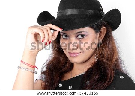 A portrait of a beautiful Indian woman in a traditional saree wearing a hat.