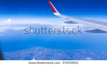 View of plane window on beach