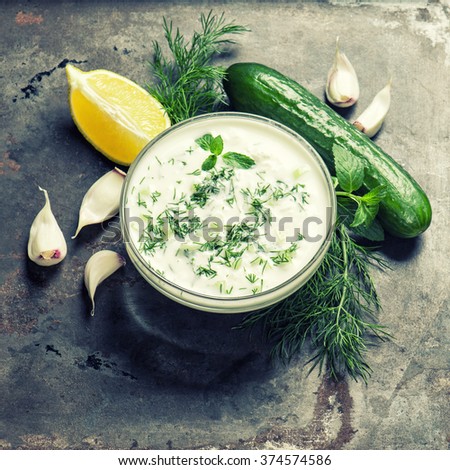 Fresh tzatziki yogurt sauce. Herbs and vegetables. Vintage style toned picture