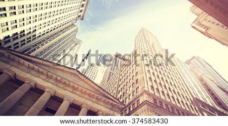Vintage toned Wall Street at sunset, Manhattan, New York City, USA. Royalty-Free Stock Photo #374583430