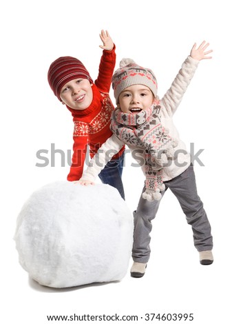 Funny adorable little children with comical big head making a snowman together, isolated on white