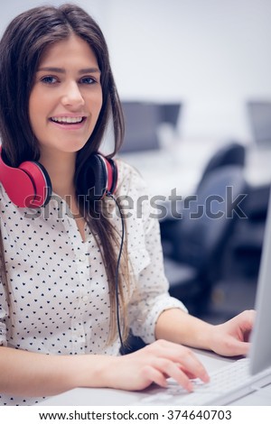 Smiling student working on computer at university