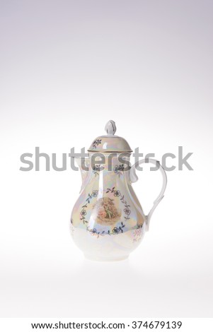 teapot with picture and floral ornate on white