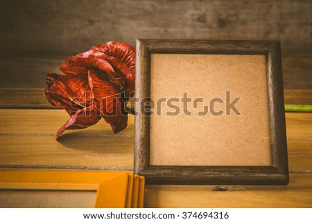 Wooden frame and flower on wooden background,Still life of love