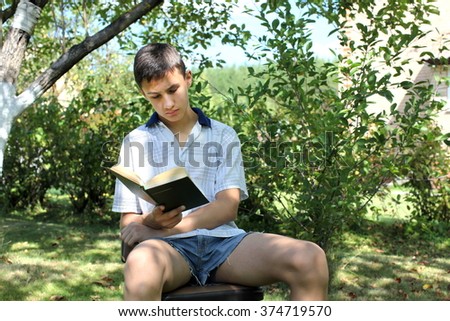boy outdoors reading book