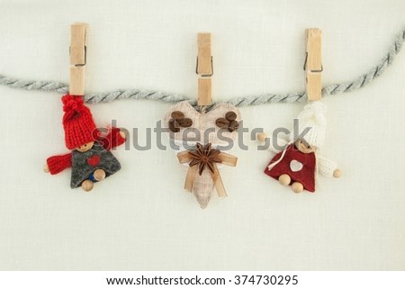 valentine, greeting card. Wooden pins, coffee brown heart, knitted loving couple man and woman hanging on a clothesline. On the cloth background