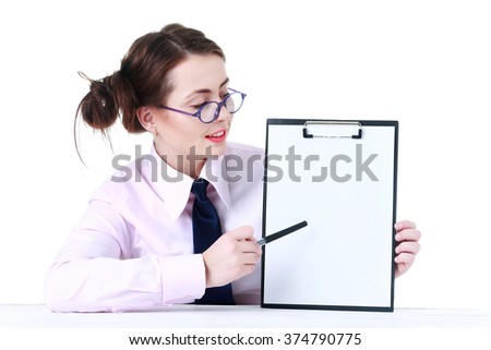 Picture of young woman student at the desk showing blank signboard
