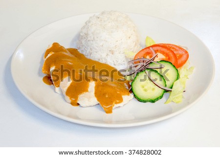 Chicken dinner with rice topped with curry sauce