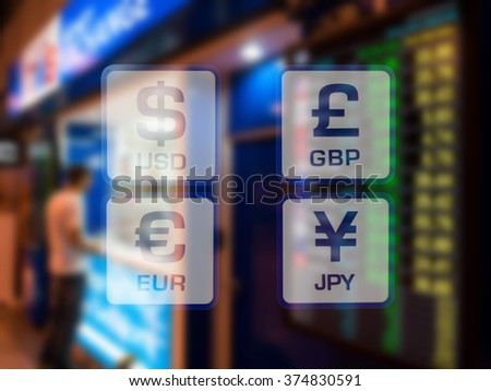 currency icons on currency exchange booth at airport blurred background