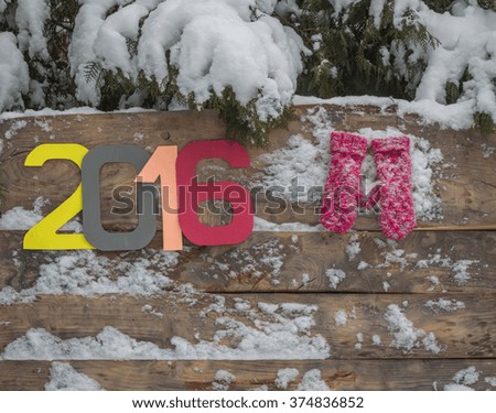 mittens on a wooden background winter