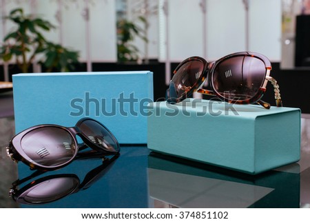 Designer Women's Sunglasses with turquoise boxes Royalty-Free Stock Photo #374851102