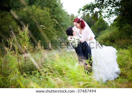 happy bride and groom having fun in the nature