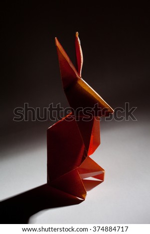 Red origami paper bunny rabbit isolated on background 