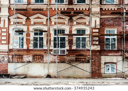 Restoration of old building  with white windows and red blocks Royalty-Free Stock Photo #374935243