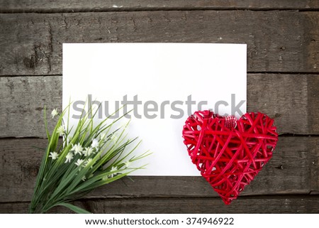 Flowers and heart shape note paper on wood background. Love concept for Valentines Day