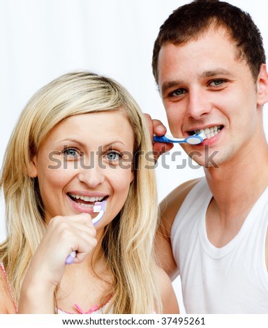 Portrait of a couple cleaning their teeth in bathroom