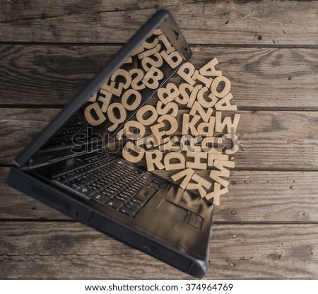wooden letters and symbols emitted from the computer screen