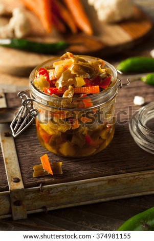 Spicy Homemade Pickled Giardiniera with Peppers, Carrots and Cauliflower Royalty-Free Stock Photo #374981155