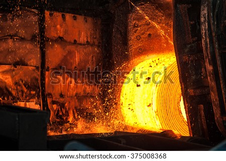 Roll of hot metal on the conveyor belt Royalty-Free Stock Photo #375008368