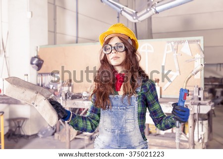 portrait of pretty female worker in a steel mill