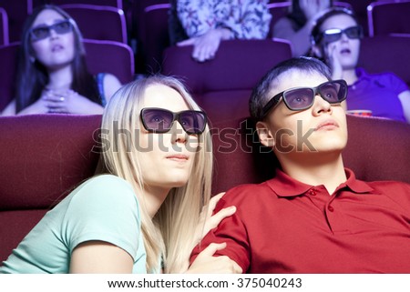 People sitting at the cinema, watching a film. Cinema photo series