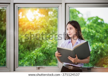 Asia students read a book in Library Royalty-Free Stock Photo #375124537