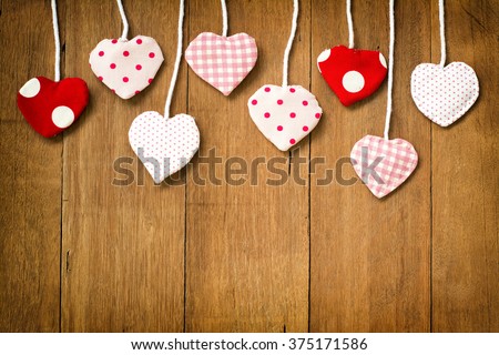 Valentine's hearts on wooden background,vignette lens style