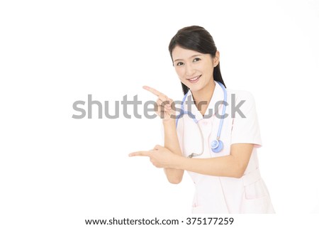 Young female nurse pointing