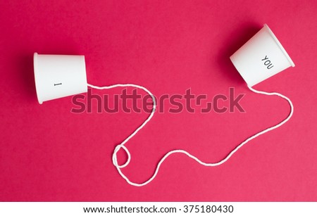 Concept of love which have couple coffee cup and connect them with white rope on red background.