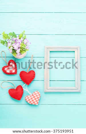 Valentine's day background with heart shapes on blue wooden table. Beautiful holiday invitation. Mock up for text. 