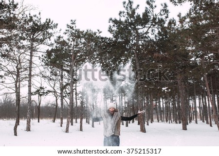 Happy woman in a winter forest.
