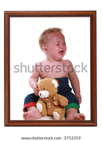 Crying baby sitting in a picture frame.