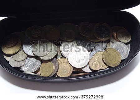 Coins falling down into the wooden casket