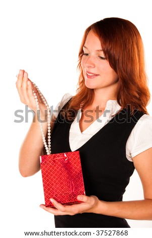 Beautiful woman is looking at her new gift - necklace - in a red box. Zoomed in version.