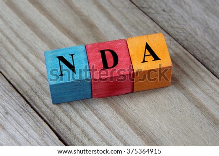 NDA (Non-Disclosure Agreement) text on colorful wooden cubes