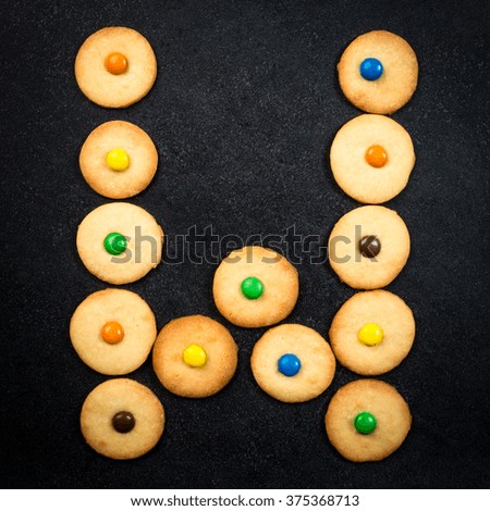 Cookie alphabet - Homemade child cookies - W letter of the alphabet - black stone background