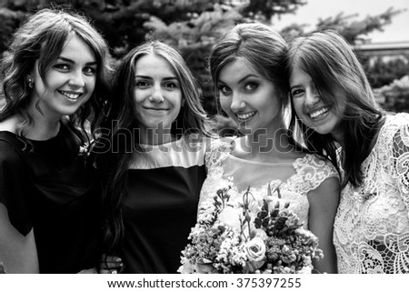 stylish happy guests and bride and bridesmaids having group photos on the sunny wedding day
