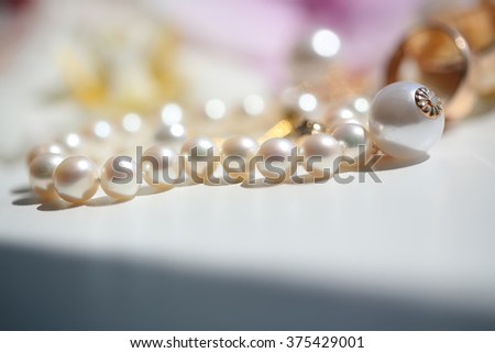 Splendid female vintage vogue bridal wedding white shining perfect round pearl bracelet jewel attractive marriage arrangement on white background closeup studio, horizontal picture 