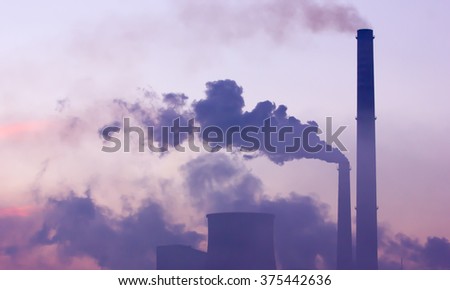 Industrial landscape at dawn. Smoking industrial chimneys at dawn. Concept for environmental protection Royalty-Free Stock Photo #375442636