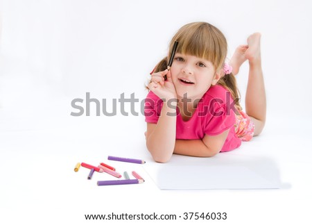 little, creative girl drawing with crayons on white