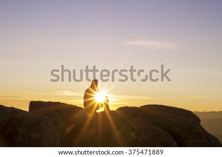 Man on top watching the sunset alone
 Royalty-Free Stock Photo #375471889