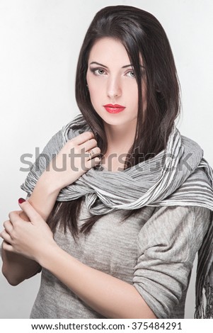 Model in striped scarf on a white background