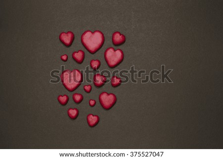 Clay red hearts on dark black background