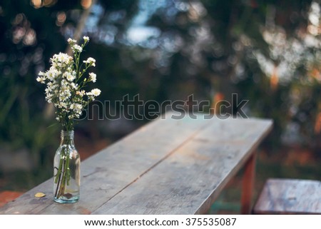 Vase on wooden desk in vintage soft tone film filter effect